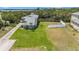 Spacious backyard featuring lush green grass, privacy fencing, and ample space for outdoor activities at 734 Weedon Ne Dr, St Petersburg, FL 33702