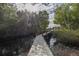 Long wooden dock leading to a covered boat lift amidst tranquil mangrove surroundings at 734 Weedon Ne Dr, St Petersburg, FL 33702