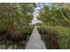 Inviting dock with covered boat lift surrounded by lush greenery and calm waters at 734 Weedon Ne Dr, St Petersburg, FL 33702