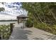 Picturesque dock with a boat lift and waterfront views surrounded by lush vegetation at 734 Weedon Ne Dr, St Petersburg, FL 33702