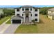 Stunning three-story modern home with a paver driveway and well-maintained landscaping at 734 Weedon Ne Dr, St Petersburg, FL 33702