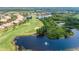 Stunning aerial view of a golf course community featuring lush greenery, serene lakes, and beautiful homes at 830 Regal Manor Way # 1, Sun City Center, FL 33573