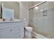 Bright bathroom with large glass shower, white cabinets, and modern fixtures at 830 Regal Manor Way # 1, Sun City Center, FL 33573