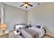 Neutral toned bedroom showcases twin beds with striped bedding, carpeted floor, and a ceiling fan at 830 Regal Manor Way # 1, Sun City Center, FL 33573