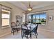 Open dining area features a dark wood table, seating for six, and a beautiful view of the lake at 830 Regal Manor Way # 1, Sun City Center, FL 33573