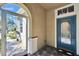 Inviting entryway with tile flooring, an ornate screen door and a beautiful blue front door at 830 Regal Manor Way # 1, Sun City Center, FL 33573