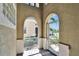 Inviting entryway features tile flooring, an ornate screen door, and views of lush landscaping at 830 Regal Manor Way # 1, Sun City Center, FL 33573