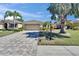 Charming single-story home boasts lush landscaping, a paver driveway, and a two-car garage at 830 Regal Manor Way # 1, Sun City Center, FL 33573