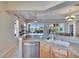 Kitchen island overlooks living room with tile floors and natural light from large windows at 830 Regal Manor Way # 1, Sun City Center, FL 33573