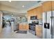 Well-lit kitchen features stainless steel appliances, light wood cabinets, and tile flooring at 830 Regal Manor Way # 1, Sun City Center, FL 33573