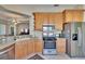Kitchen showcasing stainless appliances, solid countertops, and a view of the open living area at 830 Regal Manor Way # 1, Sun City Center, FL 33573