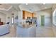 Open kitchen featuring stainless appliances, tile floors, and a view to the living areas at 830 Regal Manor Way # 1, Sun City Center, FL 33573