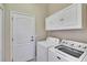 Laundry room with washer, dryer and storage cabinets at 830 Regal Manor Way # 1, Sun City Center, FL 33573