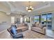 Bright living room boasts neutral walls, plush seating, tile floors, and lovely lake views at 830 Regal Manor Way # 1, Sun City Center, FL 33573