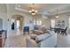 Open concept living room featuring neutral walls, tile floors, and an adjacent dining area at 830 Regal Manor Way # 1, Sun City Center, FL 33573