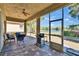 Screened lanai with seating, grill, and views of the water at 830 Regal Manor Way # 1, Sun City Center, FL 33573