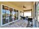 Screened lanai with seating and outdoor grill, as well as views of the lake at 830 Regal Manor Way # 1, Sun City Center, FL 33573