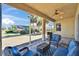 Screened lanai with outdoor seating area and views of the backyard at 830 Regal Manor Way # 1, Sun City Center, FL 33573