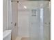 Bright bathroom showcases walk-in shower with glass door, tiled walls, and modern hardware at 830 Regal Manor Way # 1, Sun City Center, FL 33573
