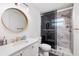 Modern bathroom featuring a sleek glass shower, white vanity, and stylish round mirror at 8871 94Th St, Seminole, FL 33777