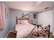 Cozy bedroom with light gray walls, wood-look floors, and a comfortable pink bed set at 8871 94Th St, Seminole, FL 33777