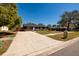 Home with a wide driveway, stone mailbox, and well-manicured lawn at 8871 94Th St, Seminole, FL 33777