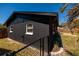 Exterior view of a dark painted home showing the corner of the building and back fence at 8871 94Th St, Seminole, FL 33777