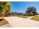Home featuring a spacious driveway and manicured front lawn, enhancing its curb appeal at 8871 94Th St, Seminole, FL 33777