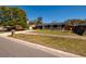 Home with large tree, stone mailbox, and well-manicured lawn at 8871 94Th St, Seminole, FL 33777
