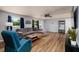 Bright living room with wood-look floors, a comfortable gray sofa, and natural light from the windows at 8871 94Th St, Seminole, FL 33777