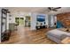 Spacious living room with wood-look floors and a modern TV setup open to the kitchen at 8871 94Th St, Seminole, FL 33777
