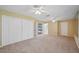 Spacious main bedroom with double closets, carpeted floors, and ample natural light from windows and doors at 9213 Cypresswood Cir, Tampa, FL 33647