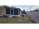 A grassy backyard and a screened-in porch are some of the features of this house at 2108 Ridgemore Dr, Valrico, FL 33594