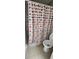 Bathroom view showcasing the polka dot shower curtain and the toilet at 2108 Ridgemore Dr, Valrico, FL 33594