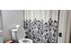 A bathroom featuring a toilet and floral curtain at 2108 Ridgemore Dr, Valrico, FL 33594