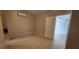 Bright bedroom showcasing tile floors, air conditioning, and convenient access to other rooms at 2108 Ridgemore Dr, Valrico, FL 33594
