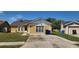 Charming single-Gathering home with well-maintained lawn, neutral color scheme, and a detached one car garage at 2108 Ridgemore Dr, Valrico, FL 33594