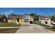 Charming single-Gathering home with well-maintained lawn, neutral color scheme, and a detached one car garage at 2108 Ridgemore Dr, Valrico, FL 33594
