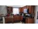 Well-equipped kitchen with solid surface countertops, wood cabinets, and modern stainless steel appliances at 2108 Ridgemore Dr, Valrico, FL 33594