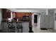 A kitchen featuring wood cabinets, stainless steel microwave, breakfast bar with two chairs, and tiled floors at 2108 Ridgemore Dr, Valrico, FL 33594