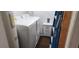 Bright laundry room with white washer and dryer, plus storage space for convenience at 2108 Ridgemore Dr, Valrico, FL 33594