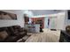 A living room with leather sofa, kitchen view, hardwood floors, and decor at 2108 Ridgemore Dr, Valrico, FL 33594
