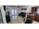 A living room and kitchen view with hardwood floors, leather sofa, sliding glass doors, and decor at 2108 Ridgemore Dr, Valrico, FL 33594