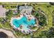 Aerial shot showcasing a community pool, surrounded by palm trees and lush landscaping at 10425 Canary Isle Dr, Tampa, FL 33647