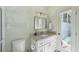 Bathroom featuring granite countertops, sleek fixtures, and a door leading to the outdoor pool area at 10425 Canary Isle Dr, Tampa, FL 33647