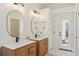 Bright bathroom features double sinks with natural wood vanities, tile flooring and white walls at 10425 Canary Isle Dr, Tampa, FL 33647