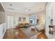 Spacious living room featuring hardwood floors, ceiling fan, and a sliding glass door to the outdoor patio at 10425 Canary Isle Dr, Tampa, FL 33647