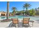 Relaxing pool area with lounge chairs, palm trees, and a nearby building at 10425 Canary Isle Dr, Tampa, FL 33647