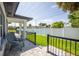 Back patio with chairs, a privacy fence, and green lawn for outdoor enjoyment at 1102 N Albany Ave, Tampa, FL 33607