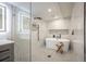 Stylish bathroom featuring a soaking tub, frameless shower, modern fixtures and hexagon tile flooring at 1102 N Albany Ave, Tampa, FL 33607